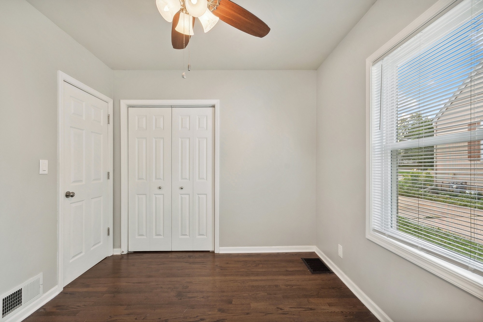 1513 Marquette Road Joliet, IL 60435 - Photo 8 of 16 a view of an empty room with wooden floor and a window