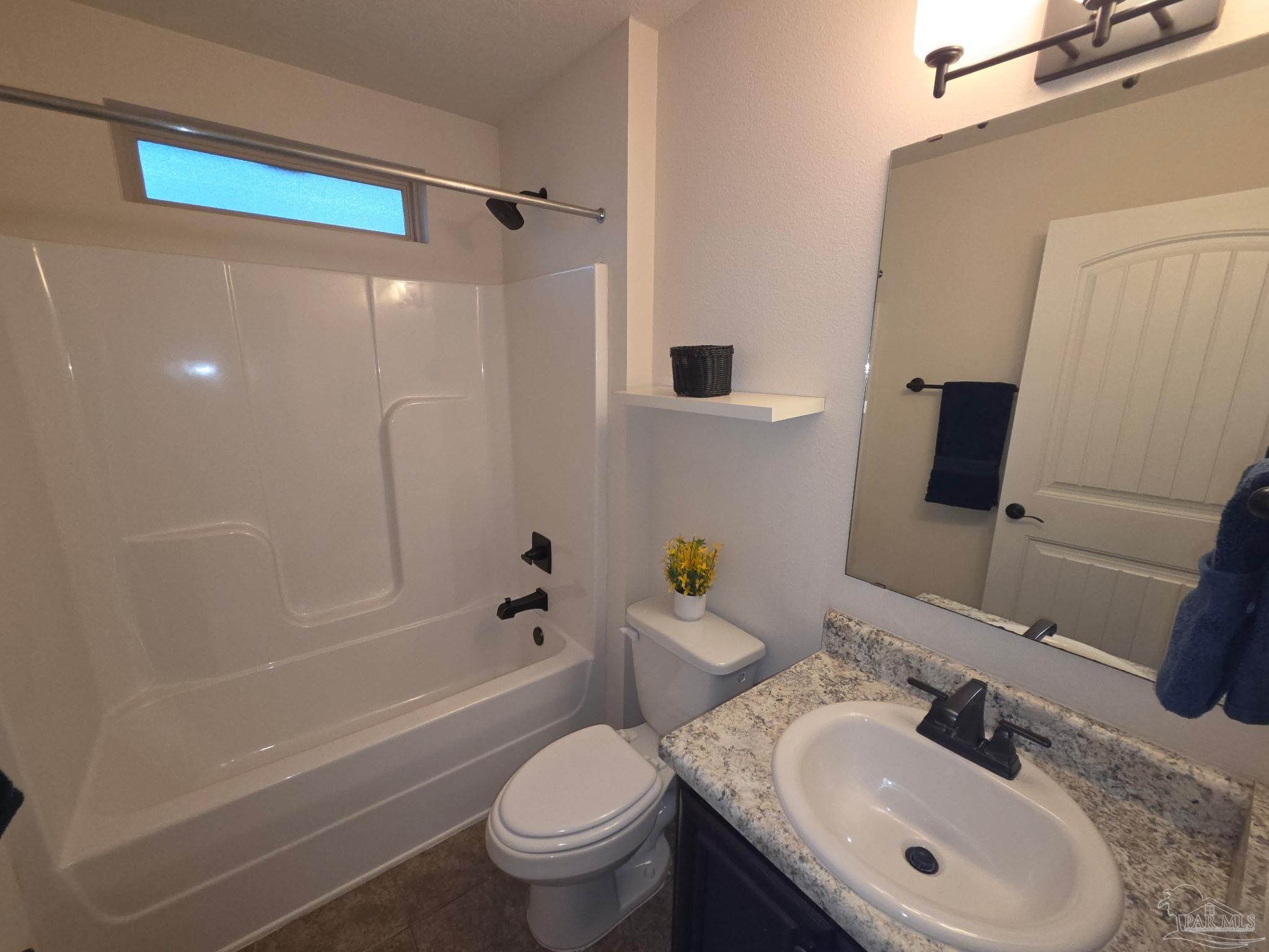 5709 Mill Stream Way Pace, FL 32571 - Photo 4 of 48 a bathroom with a sink toilet and shower