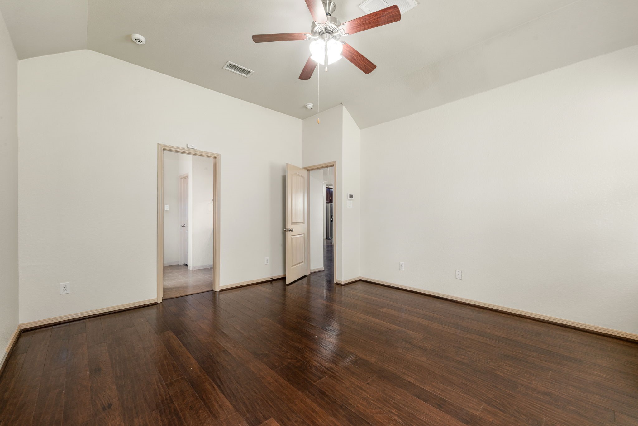 51 Handbridge Place Tomball, TX 77375 - Photo 16 of 46 a view of an empty room with wooden floor