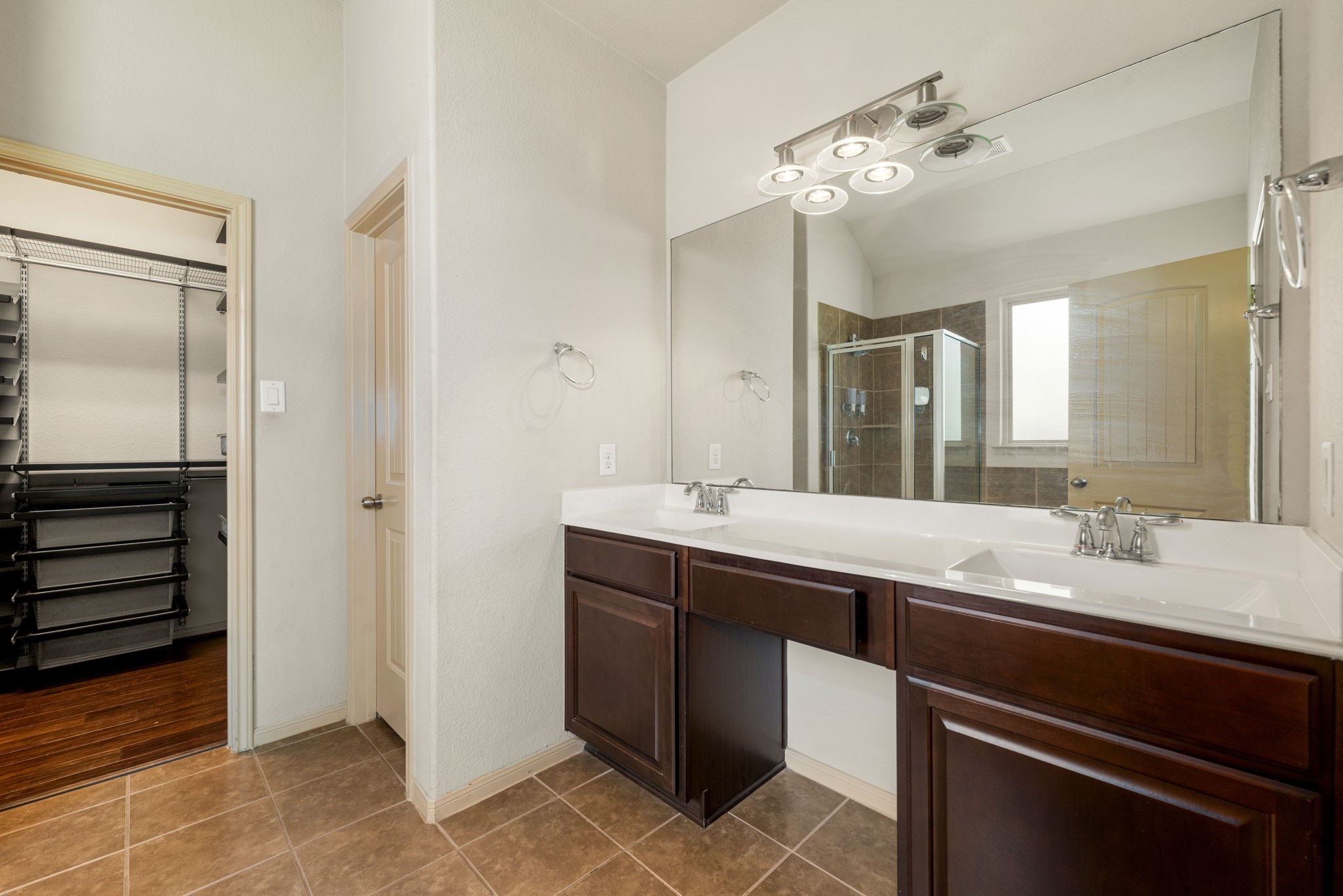 51 Handbridge Place Tomball, TX 77375 - Photo 17 of 46 a spacious bathroom with a double vanity sink and a mirror