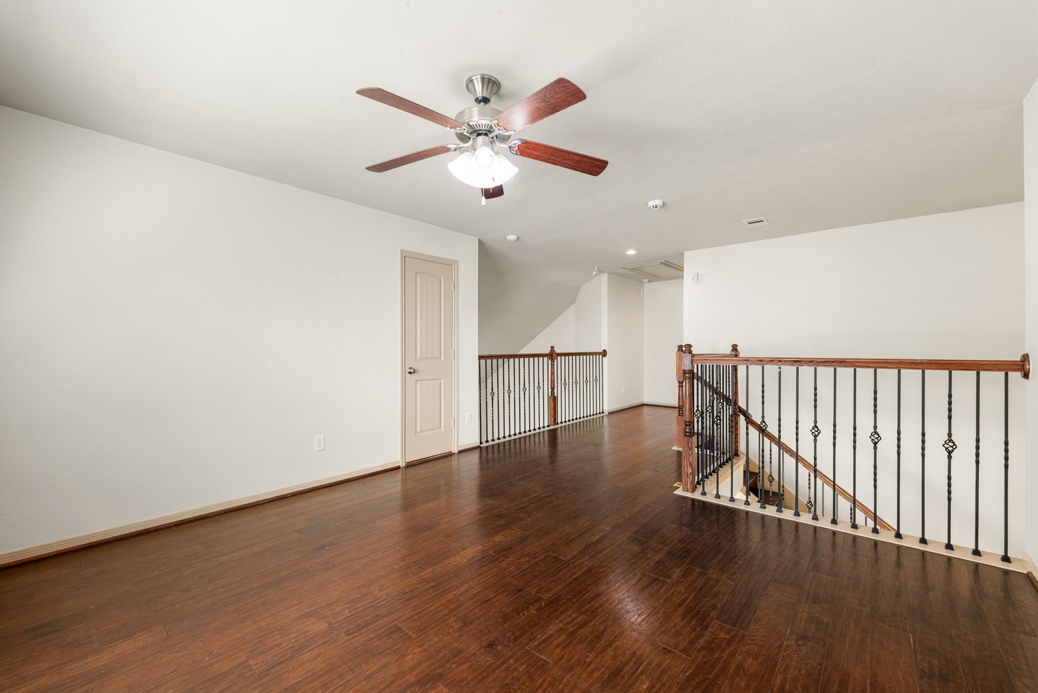 51 Handbridge Place Tomball, TX 77375 - Photo 23 of 46 a view of a hallway with wooden floor and a ceiling fan