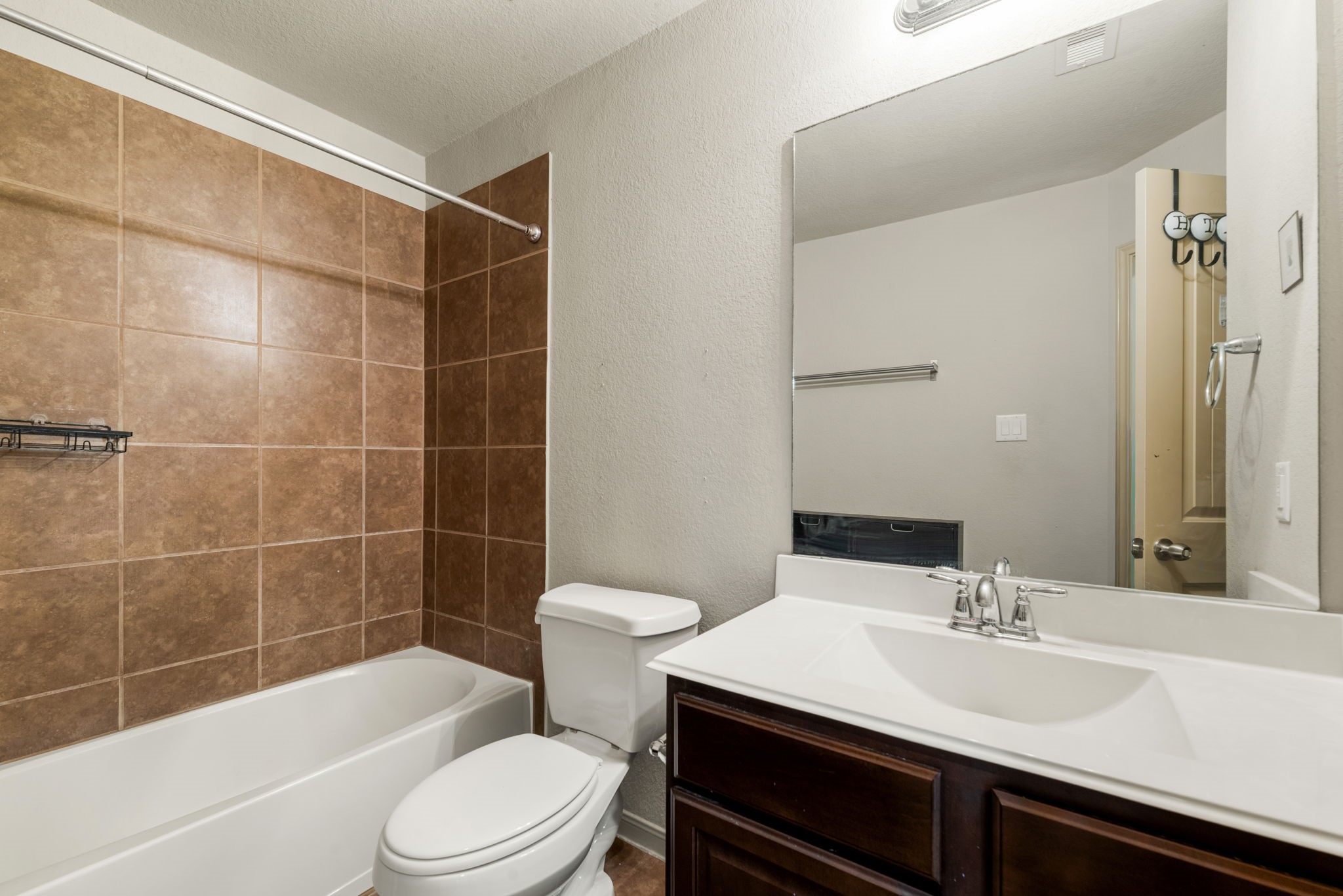 51 Handbridge Place Tomball, TX 77375 - Photo 27 of 46 a bathroom with a sink a toilet a mirror and shower