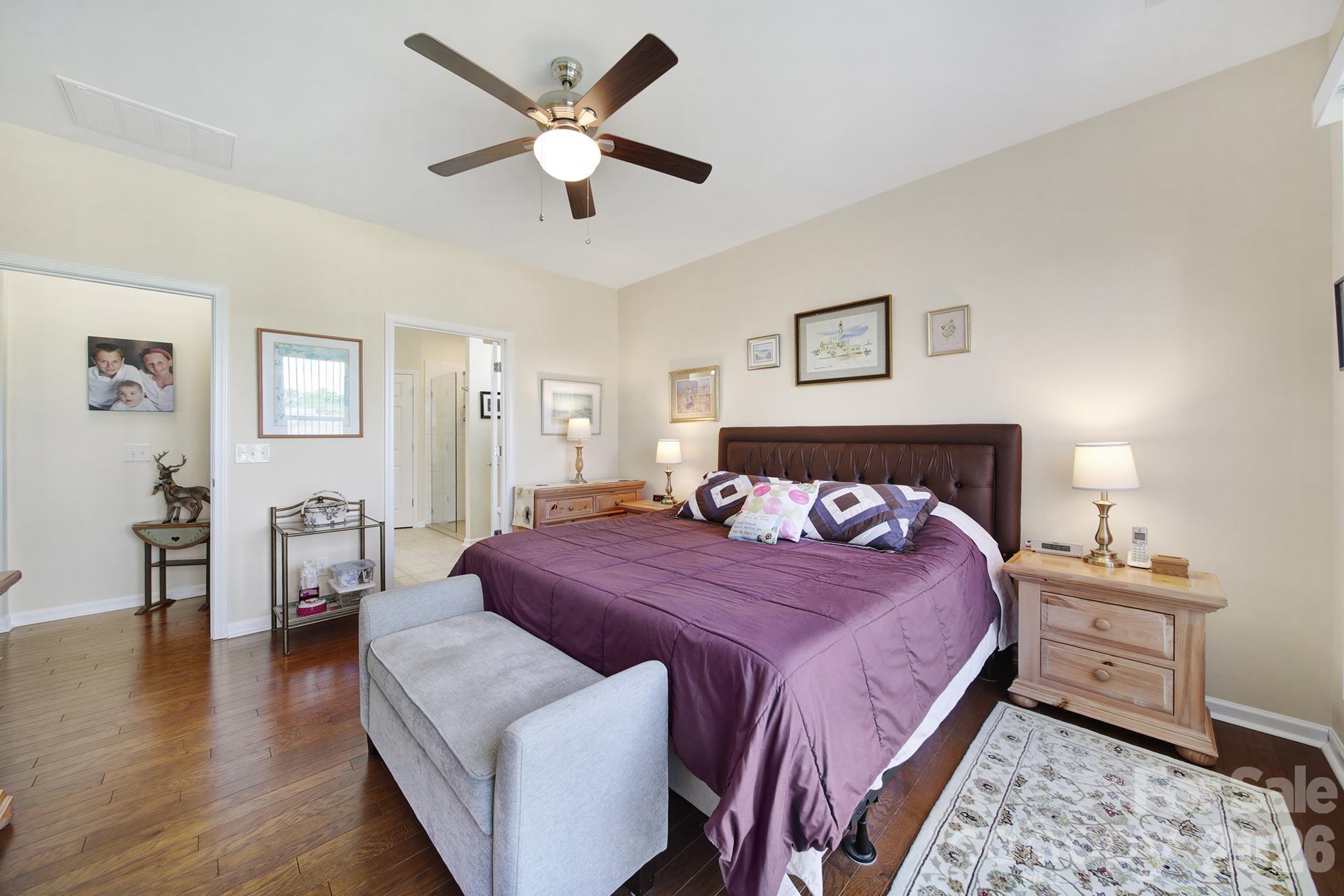 8080 Pawleys Court Fort Mill, SC 29707 - Photo 15 of 44 a bedroom with a bed chandelier and a window