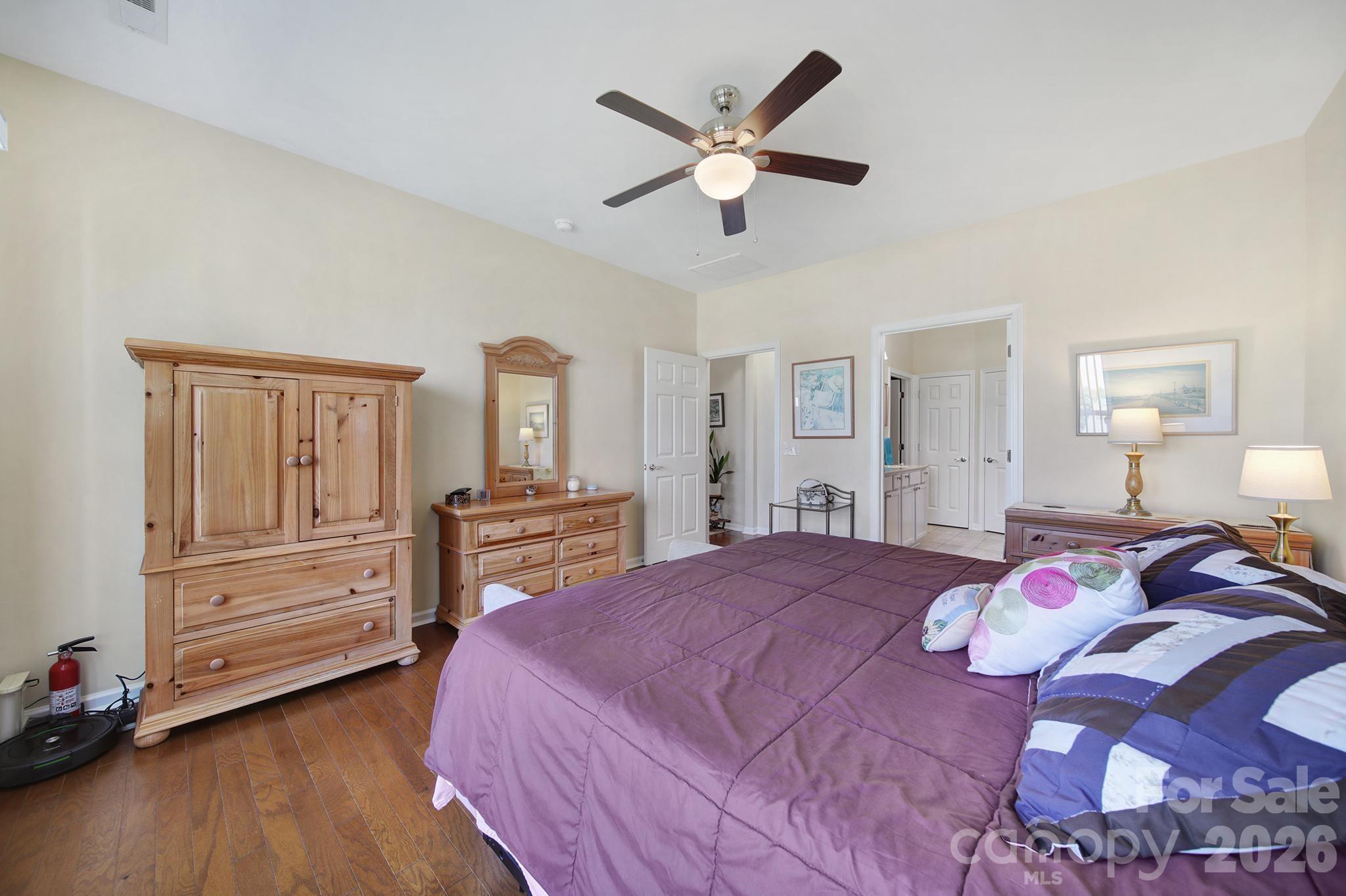 8080 Pawleys Court Fort Mill, SC 29707 - Photo 17 of 44 a bedroom with a large bed and a chandelier