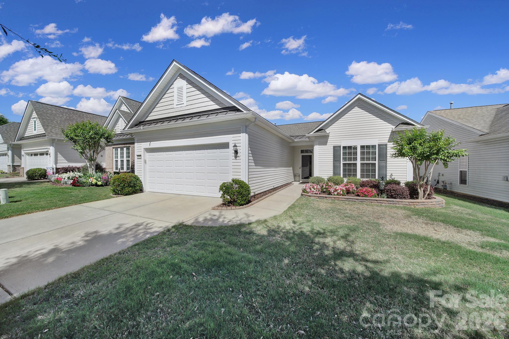 8080 Pawleys Court Fort Mill, SC 29707 - Photo 2 of 44 a front view of a house with a yard and garage