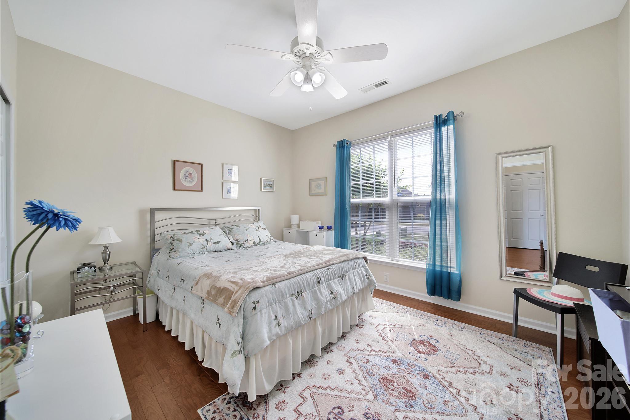 8080 Pawleys Court Fort Mill, SC 29707 - Photo 21 of 44 a bedroom with a large bed and a chandelier