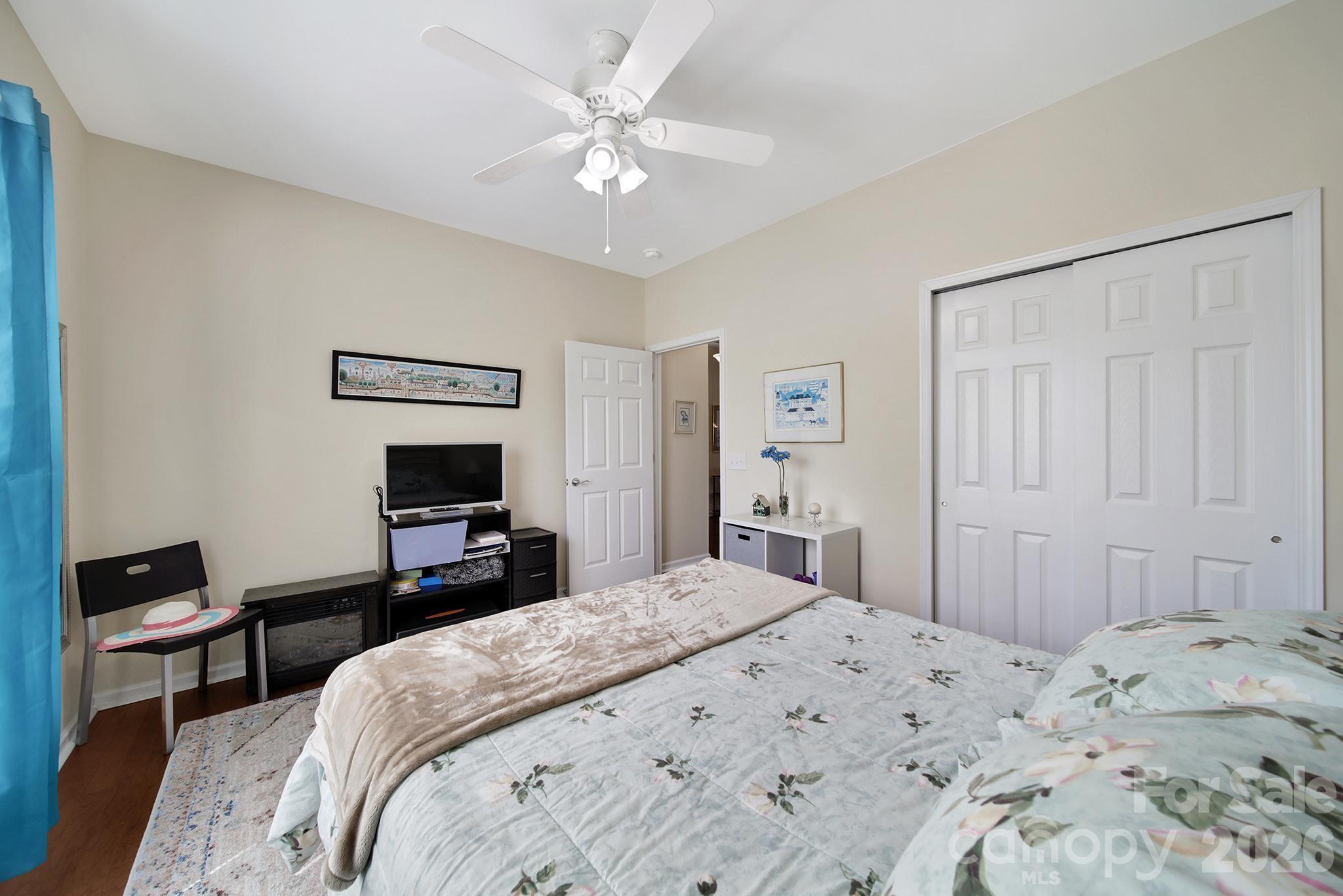 8080 Pawleys Court Fort Mill, SC 29707 - Photo 22 of 44 a bedroom with a bed and a chandelier