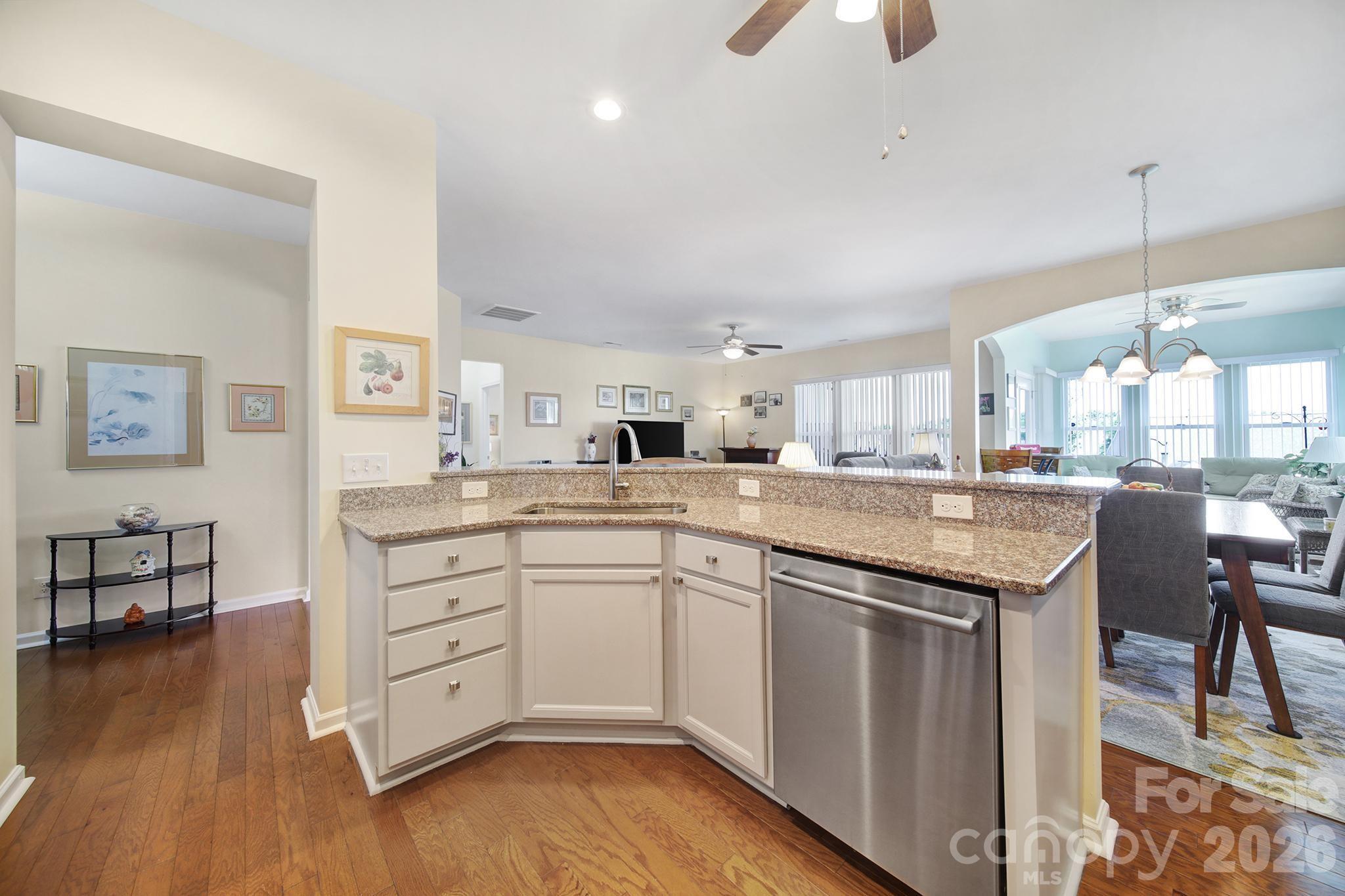 8080 Pawleys Court Fort Mill, SC 29707 - Photo 5 of 44 a kitchen with white cabinets appliances and wooden floor