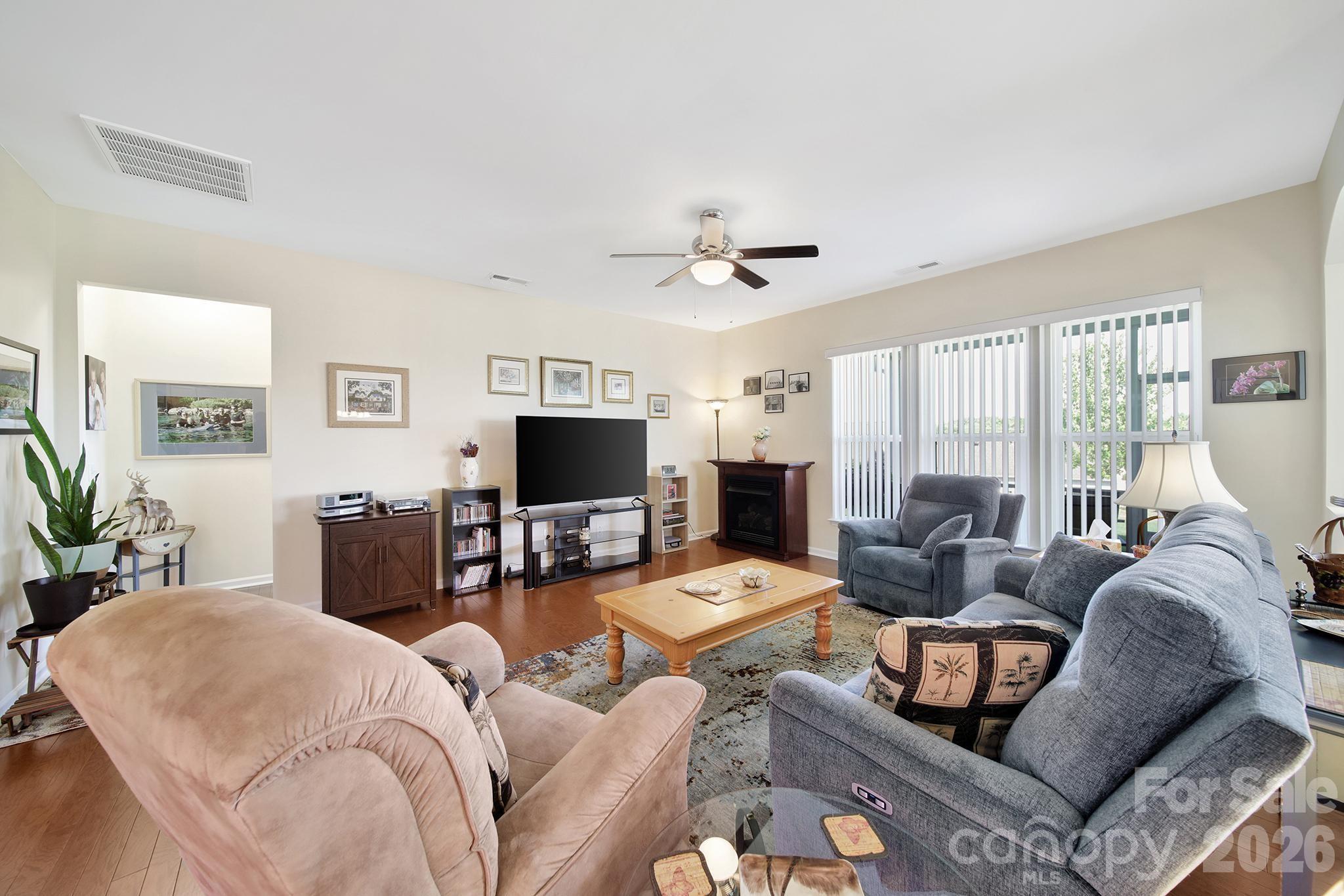 8080 Pawleys Court Fort Mill, SC 29707 - Photo 10 of 44 a living room with furniture a flat screen tv and a large window