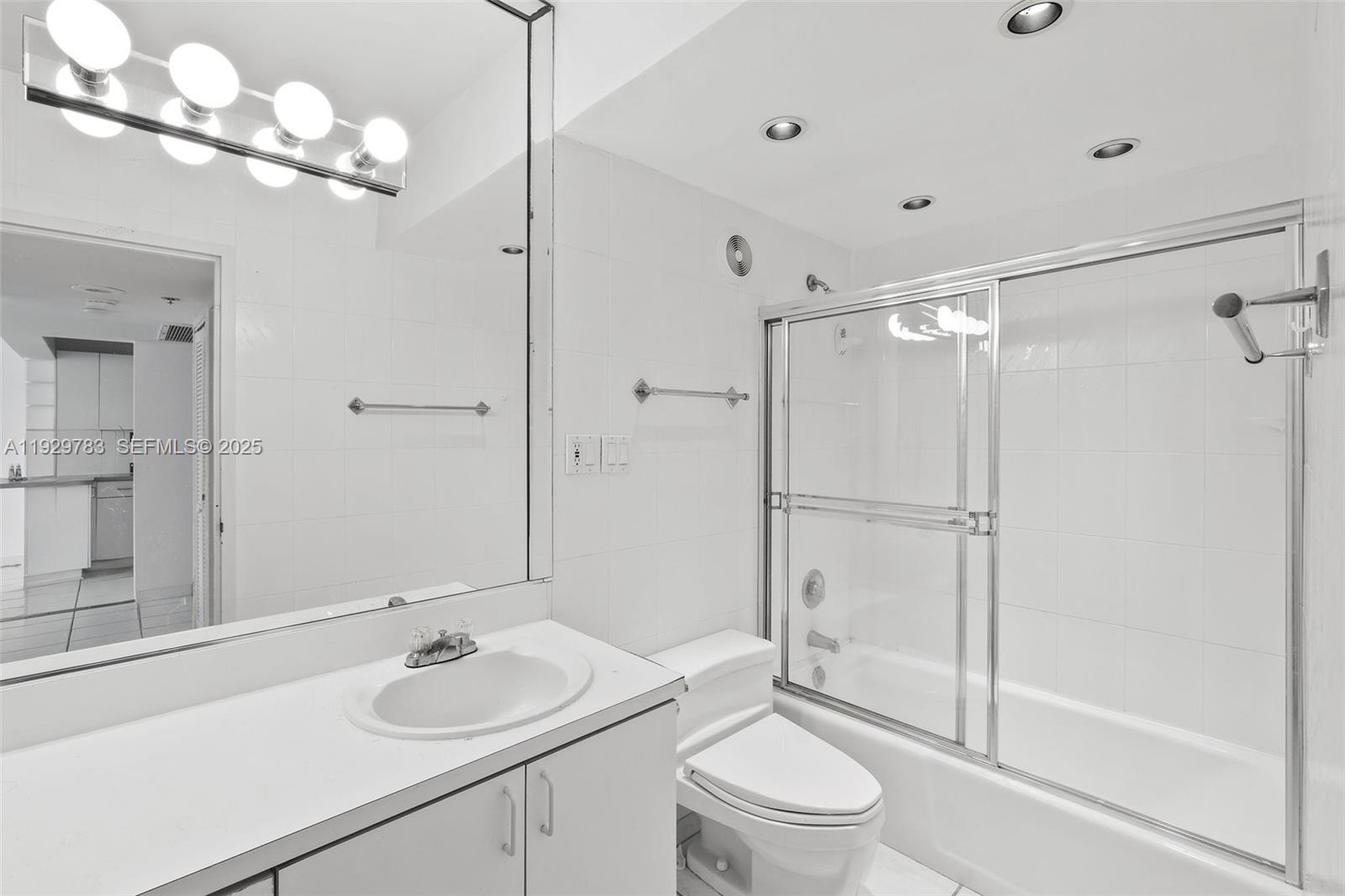 100 Lincoln Road, Unit 1444 Miami Beach, FL 33139 - Photo 24 of 38 a bathroom with a sink toilet a mirror and shower