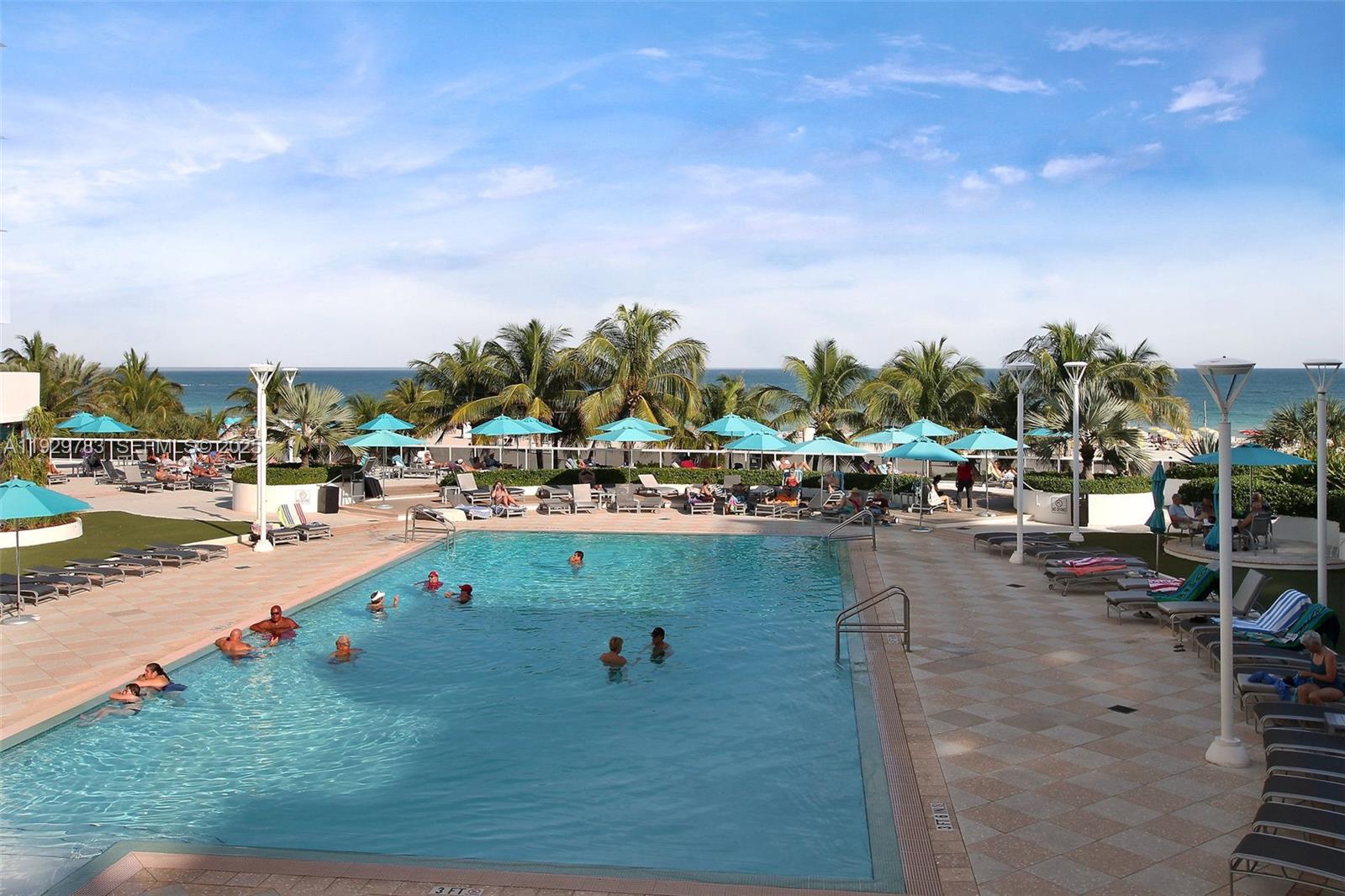 100 Lincoln Road, Unit 1444 Miami Beach, FL 33139 - Photo 38 of 38 a view of swimming pool with outdoor seating and lake in the back