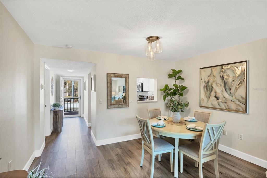210 Santa Maria Street, Unit 248 Venice, FL 34285 - Photo 12 of 72 a view of a dining room with furniture window and wooden floor