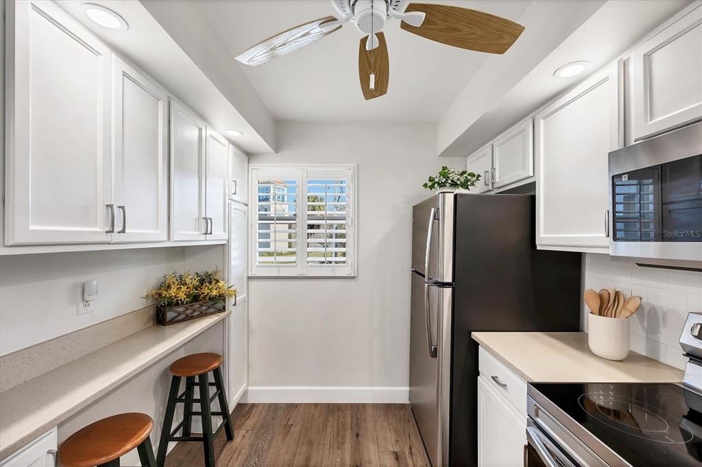 210 Santa Maria Street, Unit 248 Venice, FL 34285 - Photo 16 of 72 a kitchen with stainless steel appliances granite countertop a refrigerator and a stove top oven