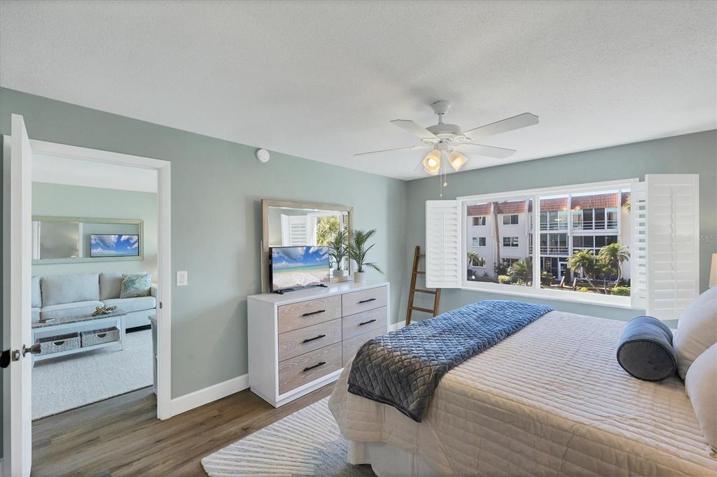 210 Santa Maria Street, Unit 248 Venice, FL 34285 - Photo 19 of 72 a spacious bedroom with a bed and a cabinets