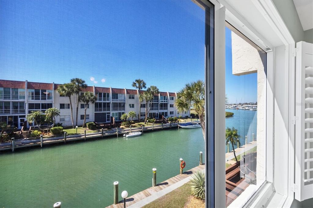 210 Santa Maria Street, Unit 248 Venice, FL 34285 - Photo 20 of 72 a view of a lake with boats and palm trees