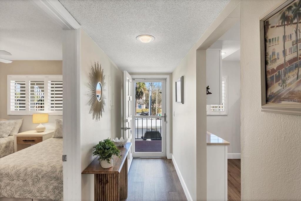 210 Santa Maria Street, Unit 248 Venice, FL 34285 - Photo 24 of 72 a view of a hallway with wooden floor and a potted plant