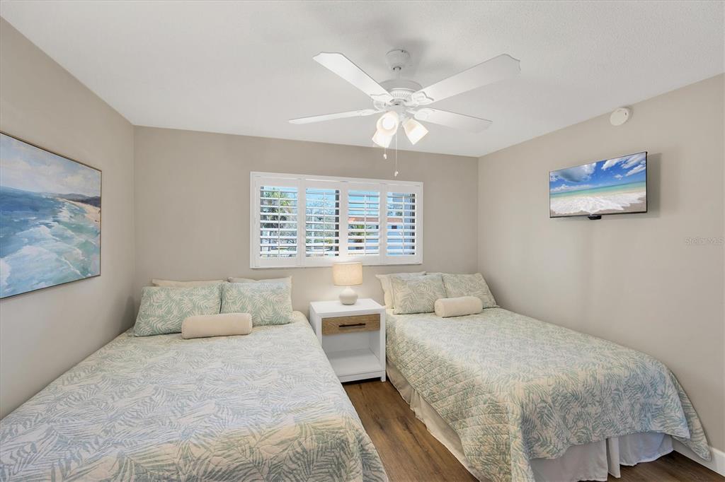 210 Santa Maria Street, Unit 248 Venice, FL 34285 - Photo 26 of 72 a bedroom with a bed and a painting on the wall