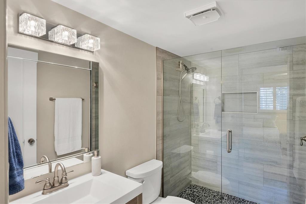 210 Santa Maria Street, Unit 248 Venice, FL 34285 - Photo 28 of 72 a bathroom with a sink vanity granite toilet and shower