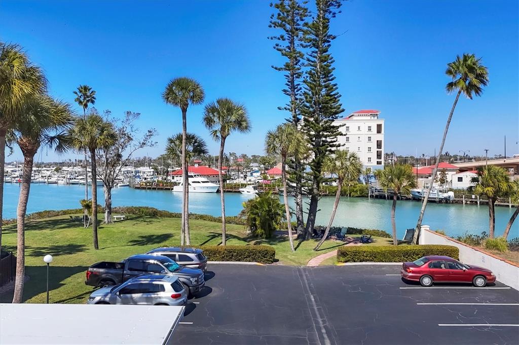 210 Santa Maria Street, Unit 248 Venice, FL 34285 - Photo 33 of 72 a car parked in front of a lake with palm trees