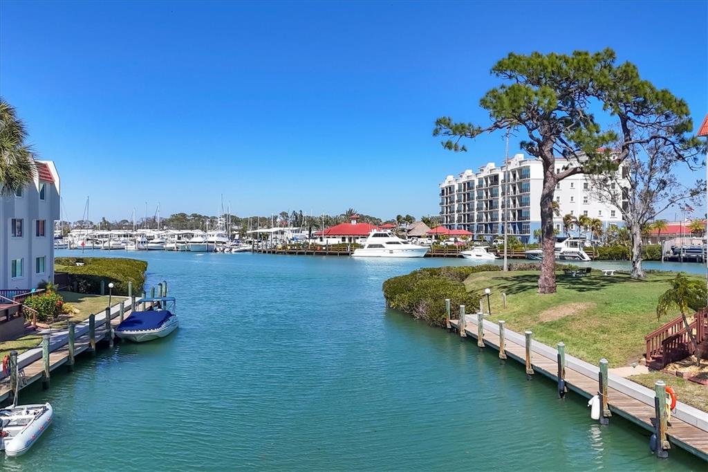 210 Santa Maria Street, Unit 248 Venice, FL 34285 - Photo 42 of 72 a view of a lake with lawn chairs and a fire pit