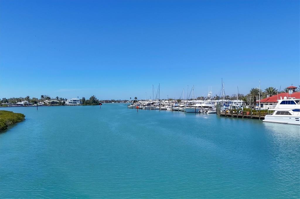 210 Santa Maria Street, Unit 248 Venice, FL 34285 - Photo 48 of 72 a view of an ocean with boats and trees in the background