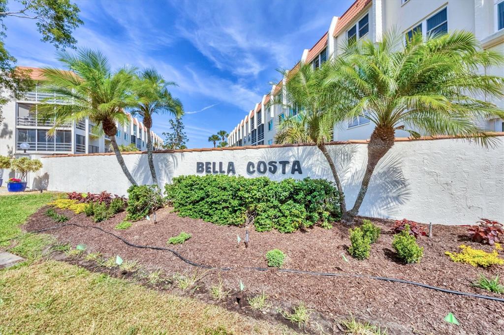 210 Santa Maria Street, Unit 248 Venice, FL 34285 - Photo 53 of 72 a front view of a house with a yard and potted plants