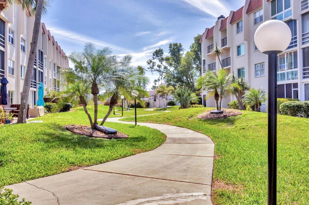 210 Santa Maria Street, Unit 248 Venice, FL 34285 - Photo 58 of 72 a front view of a building with a yard