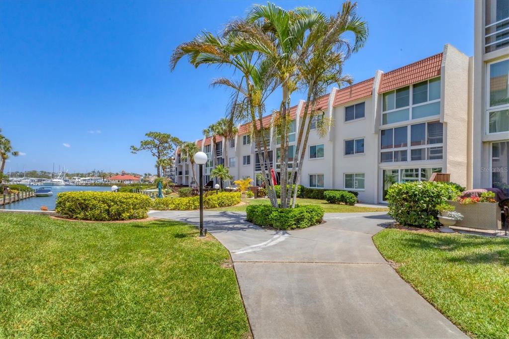 210 Santa Maria Street, Unit 248 Venice, FL 34285 - Photo 60 of 72 a view of a garden with a building in the background