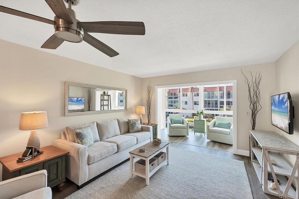 210 Santa Maria Street, Unit 248 Venice, FL 34285 - Photo 6 of 72 a living room with furniture and a flat screen tv