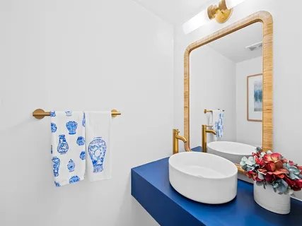 a bathroom with a sink mirror and vanity