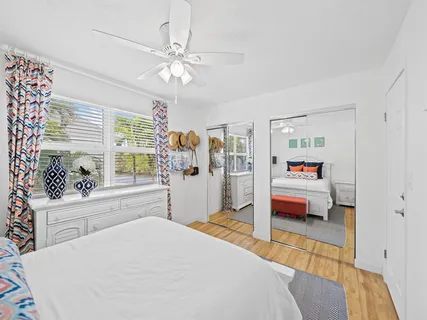 a bedroom with a bed and a large window