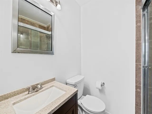 a bathroom with a sink toilet and mirror