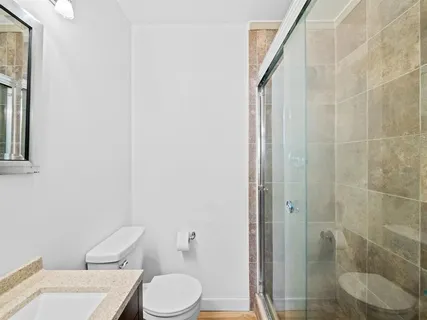 a white toilet sitting next to a bathroom sink