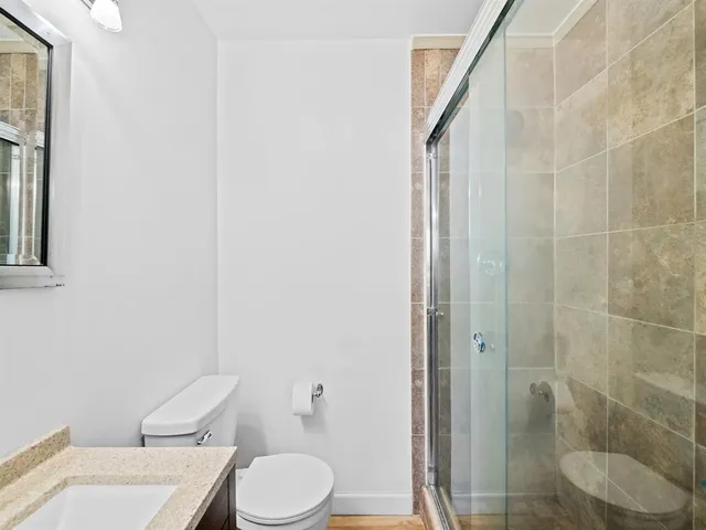 a white toilet sitting next to a bathroom sink