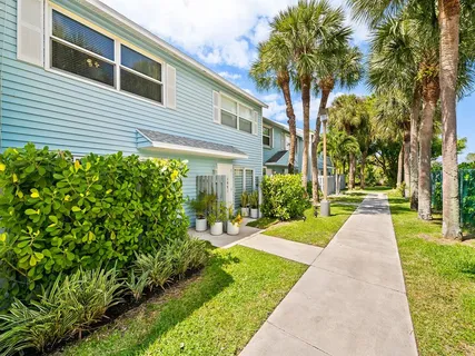 a front view of a house with a yard and fountain