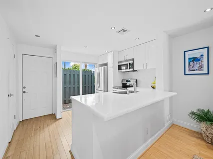 a view of kitchen island with furniture and wooden floor