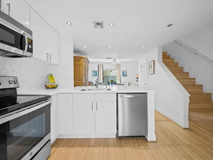 a kitchen with a sink cabinets and stainless steel appliances