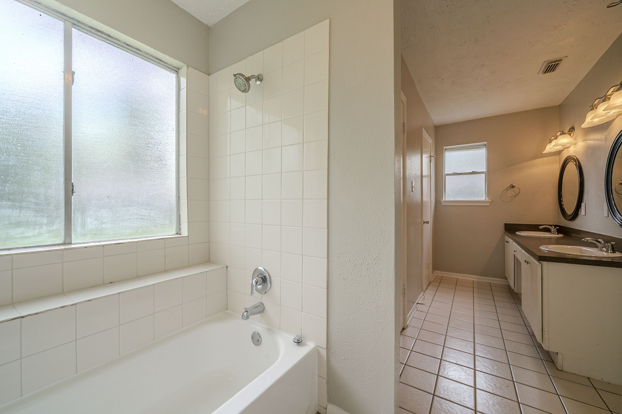 4127 Adonis Drive Spring, TX 77373 - Photo 12 of 20 a bathroom with a granite countertop sink a mirror and a bathtub