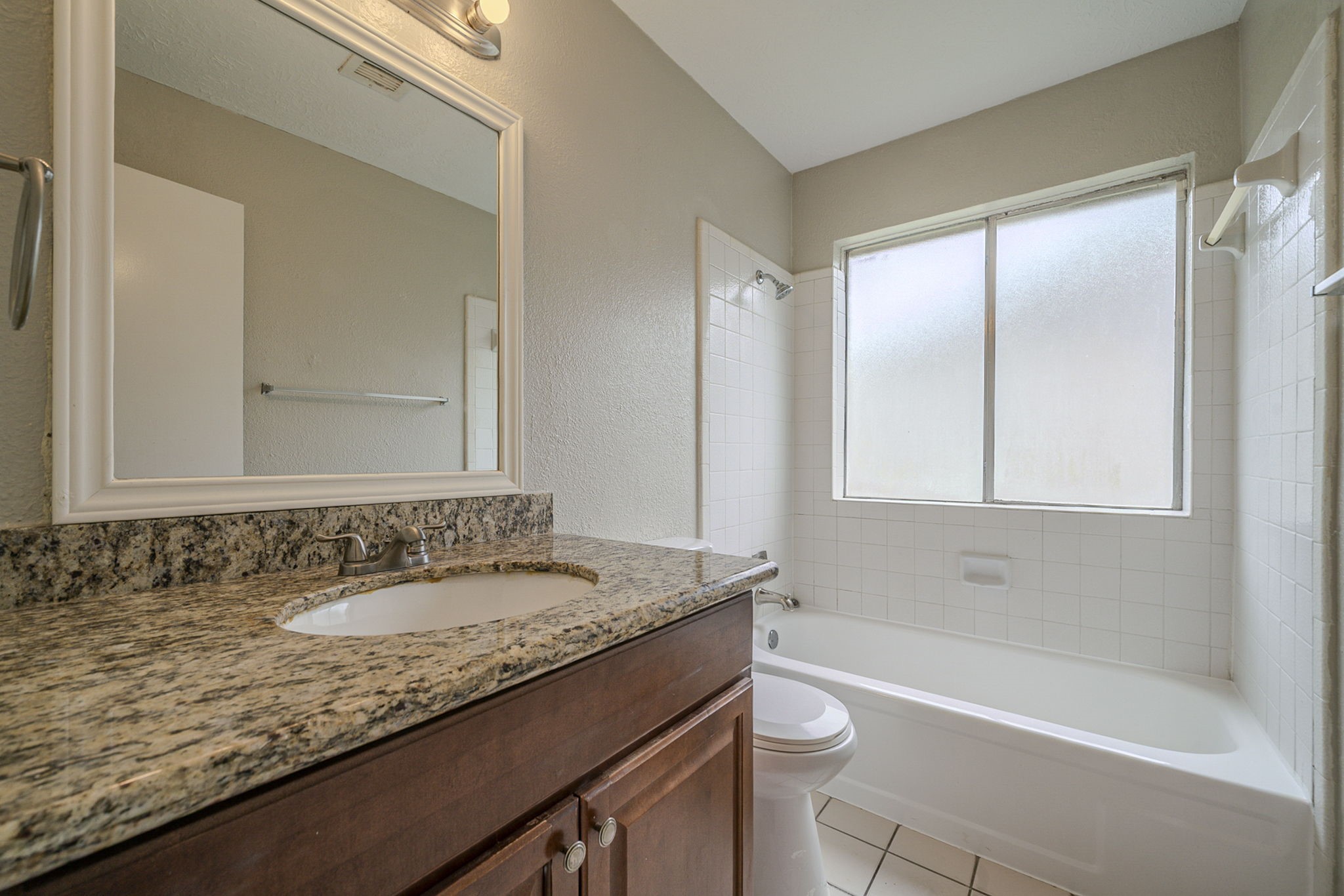 4127 Adonis Drive Spring, TX 77373 - Photo 13 of 20 a bathroom with a granite countertop sink a toilet and bathtub
