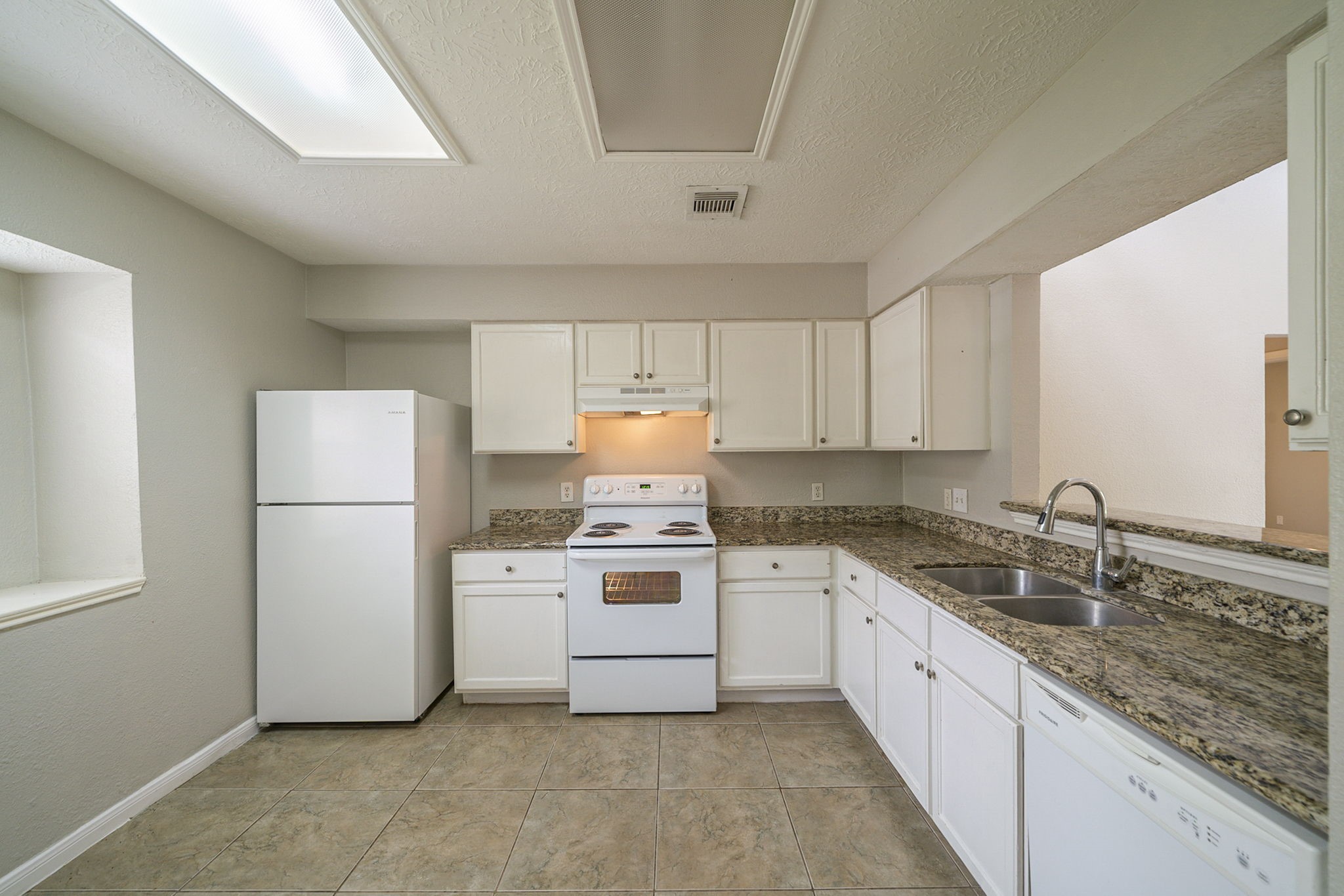 4127 Adonis Drive Spring, TX 77373 - Photo 6 of 20 a kitchen with a sink a stove a refrigerator and cabinets