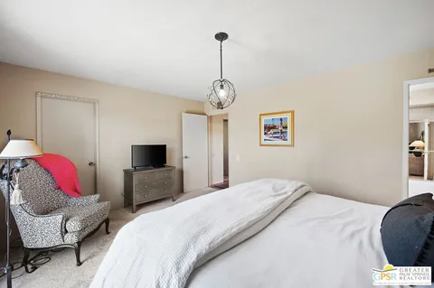 a bedroom with a bed and a tv