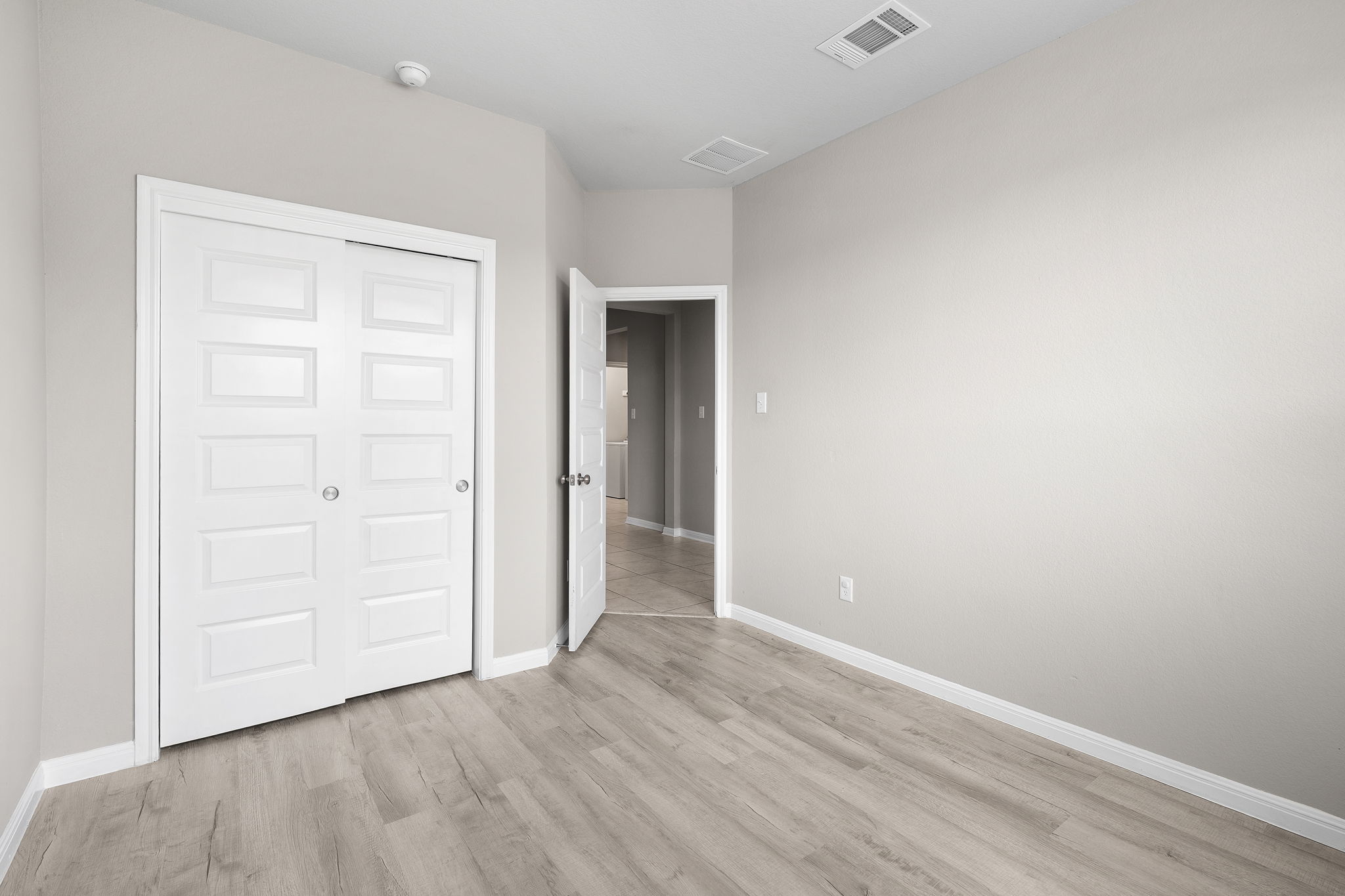 313 Mclintock Road Jarrell, TX 76537 - Photo 6 of 40 An inviting room awaits with resilient flooring and ample storage behind pristine doors.