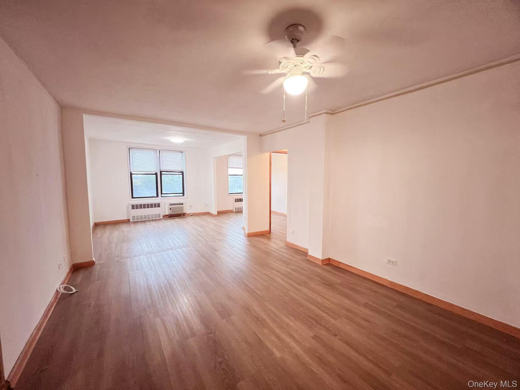 15272 Melbourne Avenue, Unit 3A Queens, NY 11367 - Photo 12 of 13 wooden floor in an empty room with a window