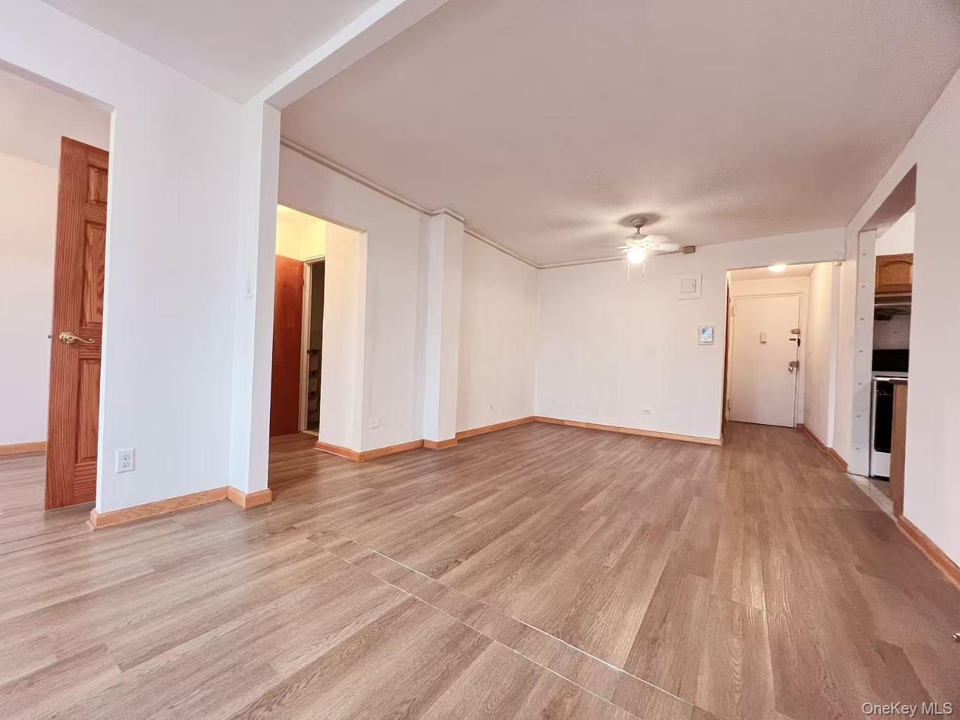 15272 Melbourne Avenue, Unit 3A Queens, NY 11367 - Photo 5 of 13 a view of empty room with wooden floor