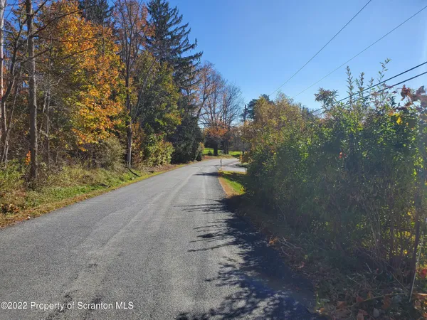 a view of a road with a yard