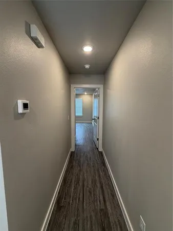 a view of hallway with wooden floor