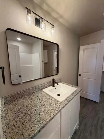 a bathroom with a sink and a mirror