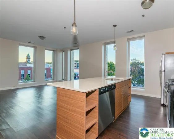 a kitchen with stainless steel appliances granite countertop a stove and a wooden floors