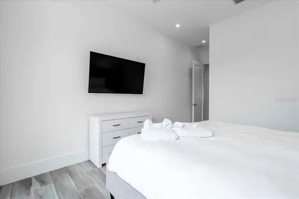a large white bed in a white room