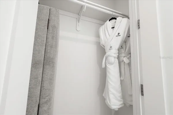 a bedroom with two beds and white walls